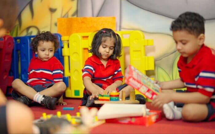Children happily playing and learning in kindergarten